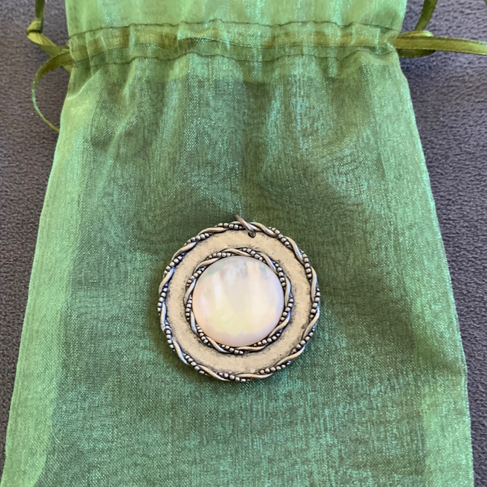 Pearl and silver colored necklace pendant